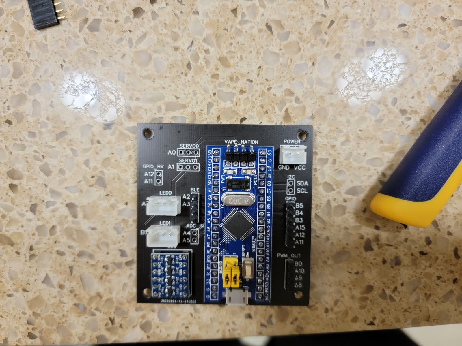 Custom black carrier PCB with an STM32 Blue Pill