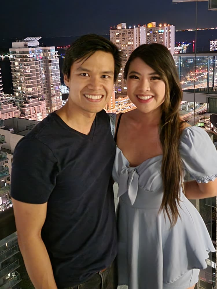 Edward and his wife on a balcony above the city lights at night